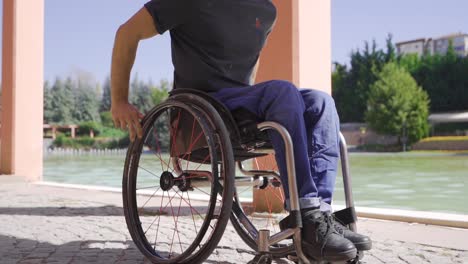 In-slow-motion,-physically-disabled-man-uses-a-wheelchair.